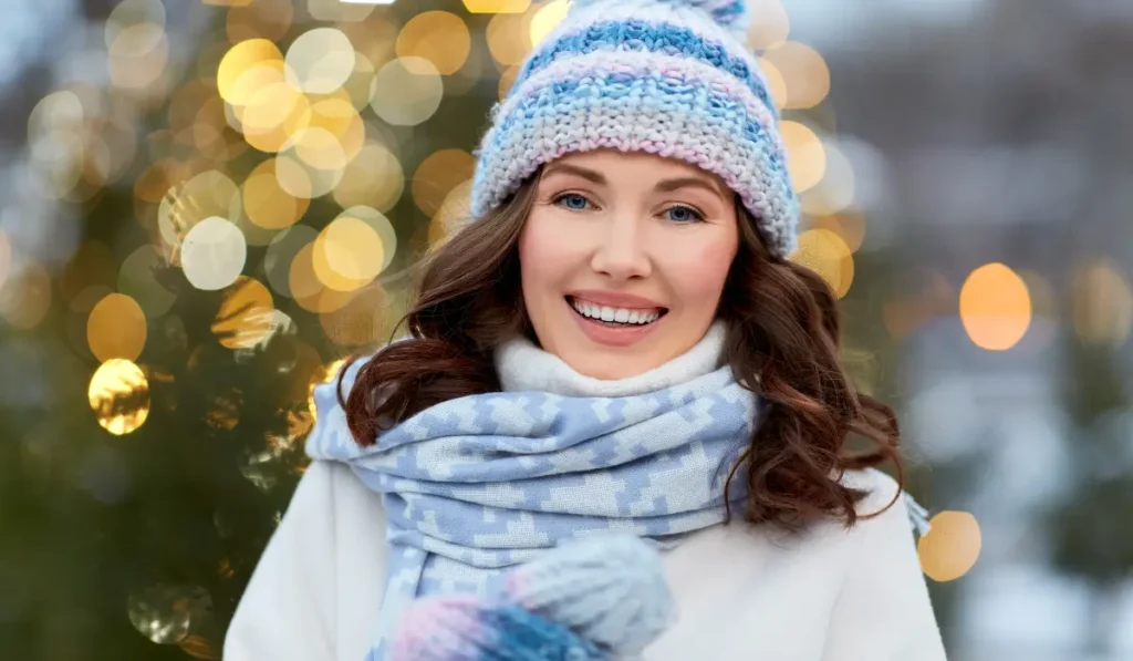 Woman smiling outdoors in winter after smile makeover using non surgical cosmetic dental treatments