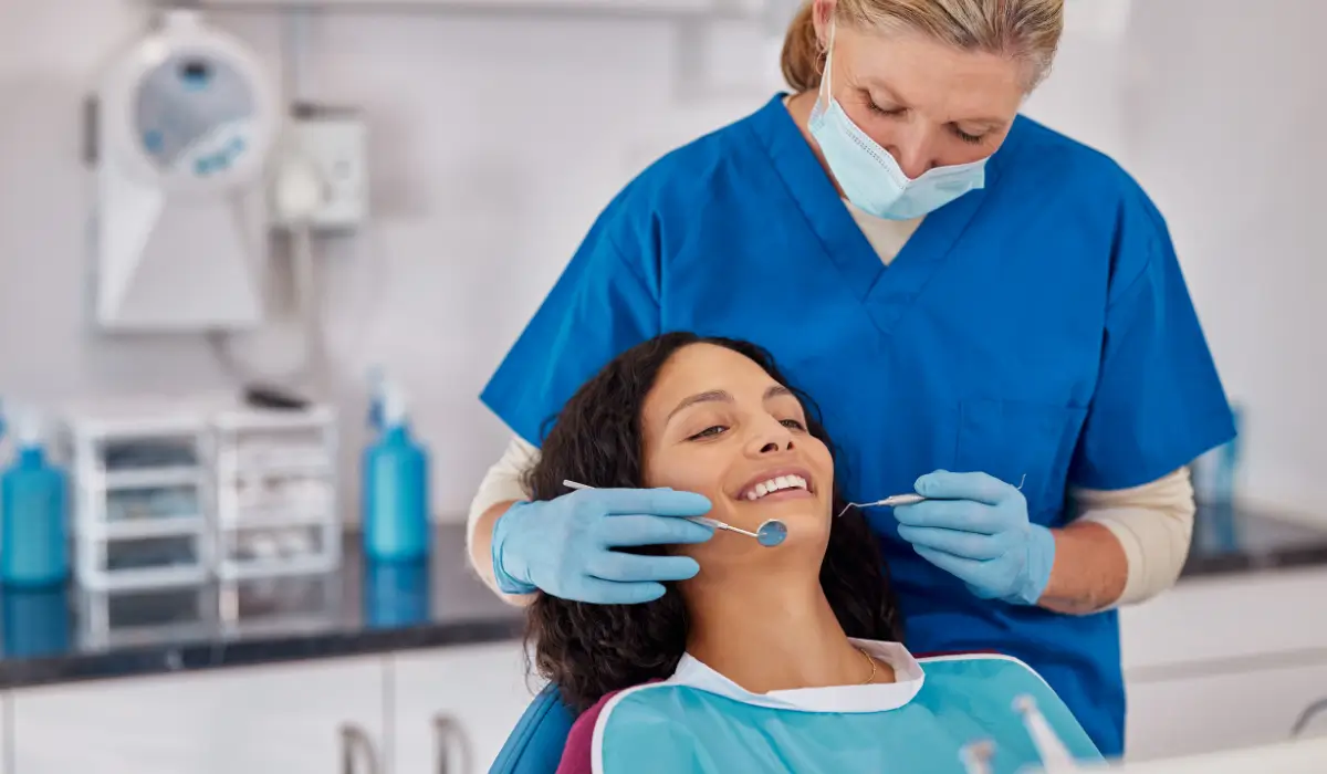 Dental Checkup showing smiling patient receiving professional oral exam with dentist using tools for preventive care.