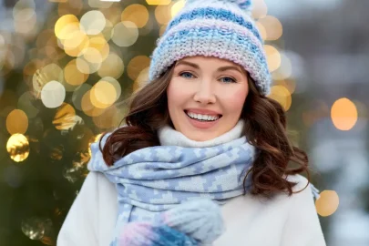 Woman smiling outdoors in winter after smile makeover using non surgical cosmetic dental treatments