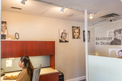 Receptionist assists patient using dental insurance benefits before December 31 in a modern Hinsdale dental office.